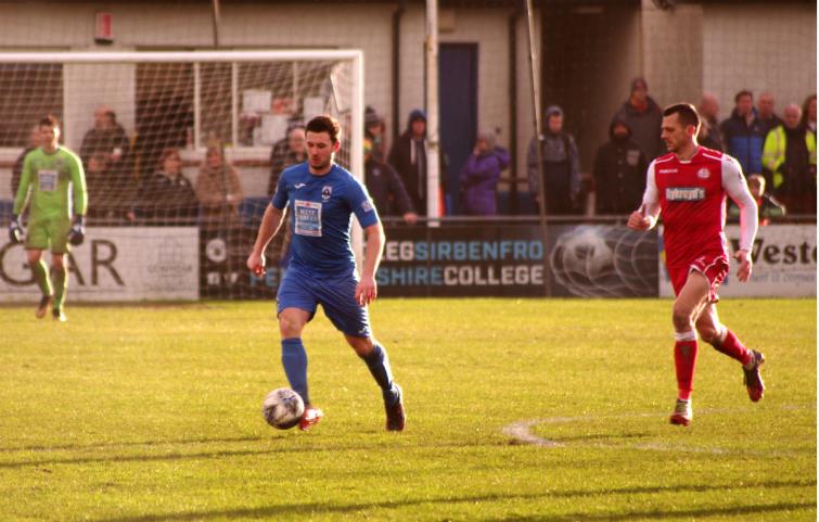 Ricky Watts plays the ball out of defence for Haverfordwest County